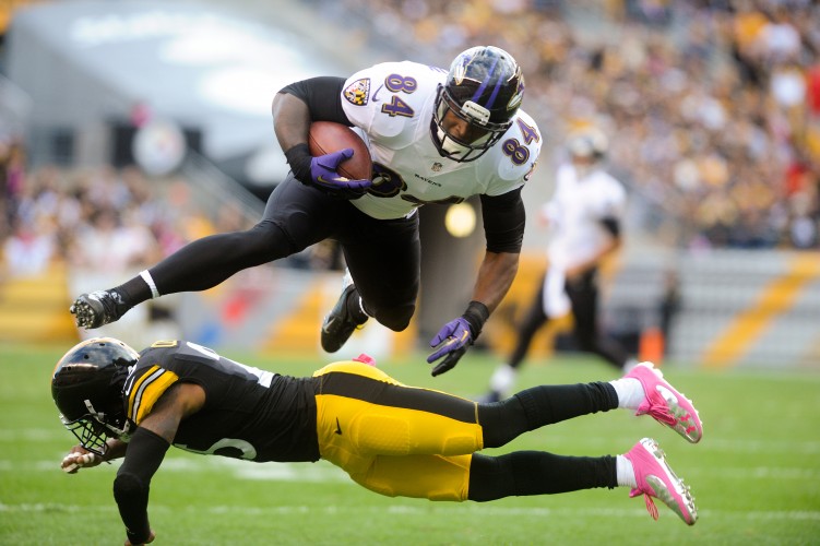 Baltimore Ravens Ed Dickson leaps over Ryan Clark